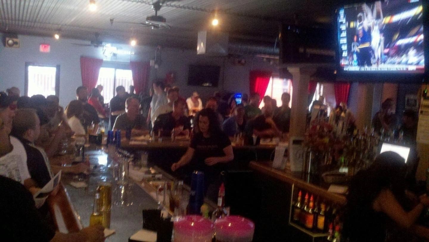 A group of people sitting at the bar